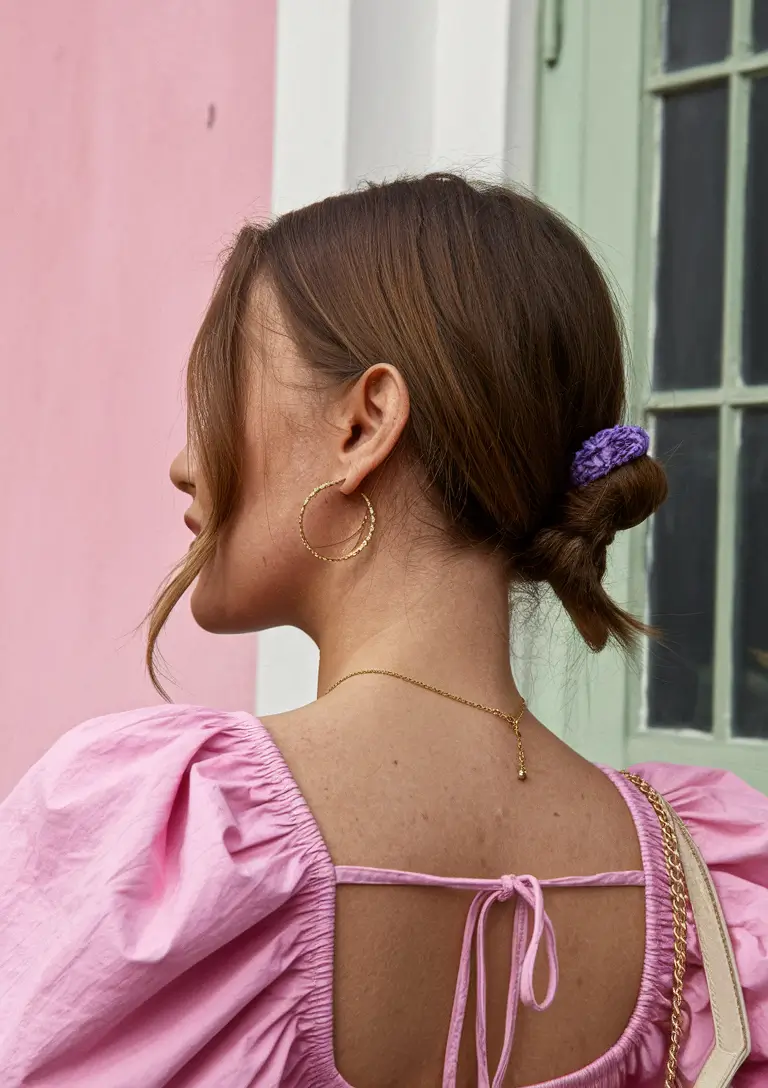 medium hair summer hairstyles Low Knotted Bun with Lilac Scrunchie
