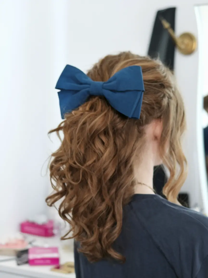 back to school hairstyles Textured Low Ponytail with a Statement Bow